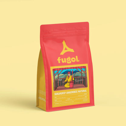 A red stand-up pouch of Fugol Sukanrip Anacohri Natural coffee, featuring a yellow logo and a colorful illustration on the front, set against a solid pale yellow background.
