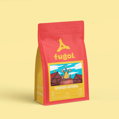 A red stand-up pouch of Fugol Semendo Natural coffee, featuring a yellow logo and a colorful illustration of a windmill, set against a solid pale yellow background.