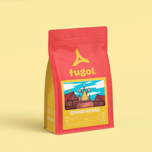 A red stand-up pouch of Fugol Semendo Natural coffee, featuring a yellow logo and a colorful illustration of a windmill, set against a solid pale yellow background.